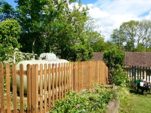 Picket fence protecting oil tank in a school